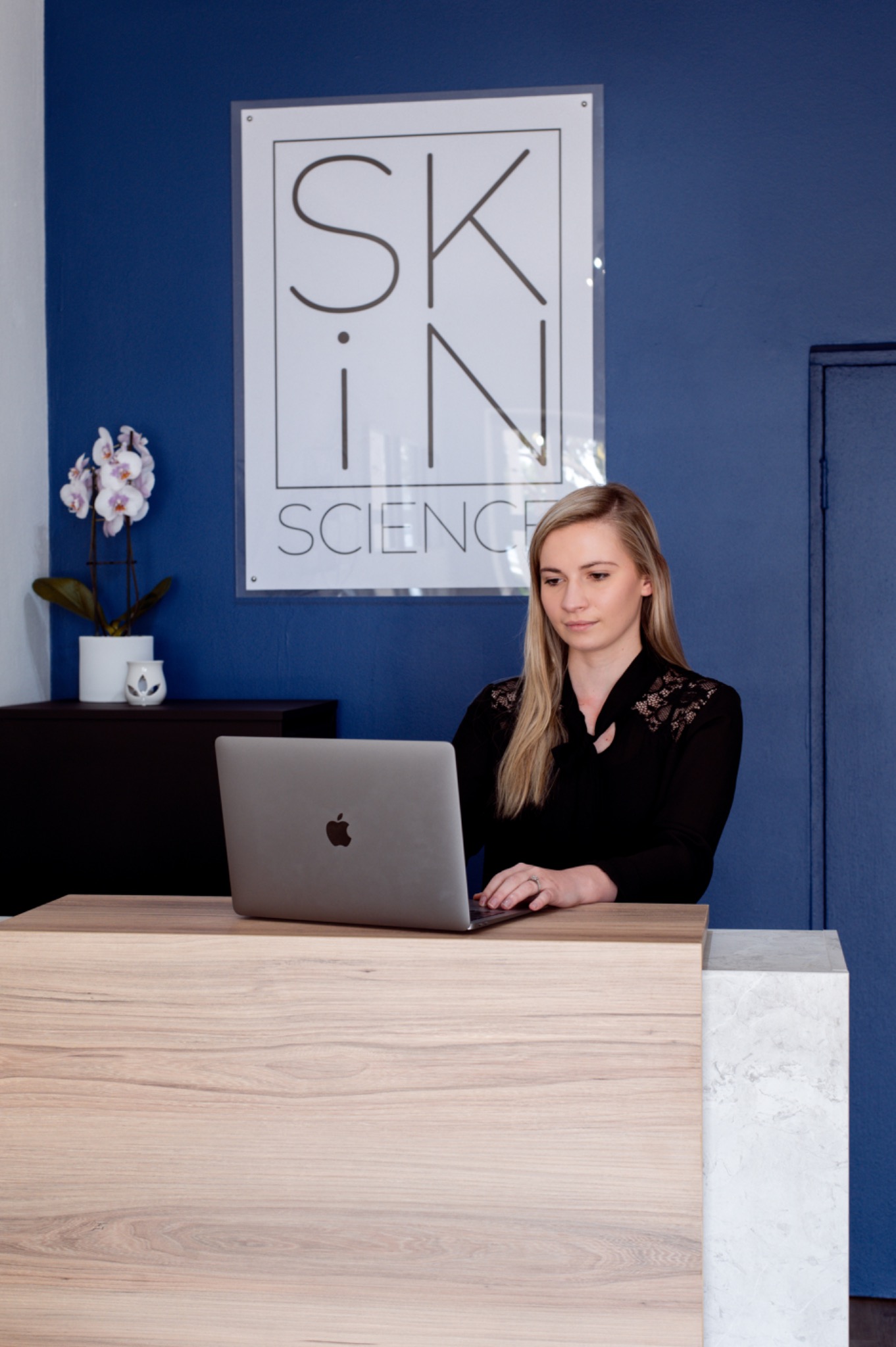 Yulabe Nel welcoming clients at the SkinScience reception